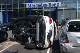 A woman flipped the Mercedes SUV she was test-driving at at the Mercedes-Benz of Arlington dealership on North Glebe Road in Ballston on Friday, August 19, 2016. (Courtesy  Arlington County Fire Department). 