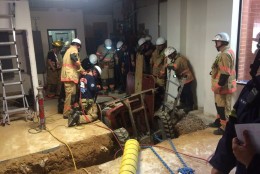 Rescuers work to extract an injured Bobcat operator after his vehicle crashed and trapped him in a trench in Rockville, Md. Emergency personnel say his injuries aren't life threatening. (Pete Piringer/Montgomery Count Fire & Rescue Service via Twitter)