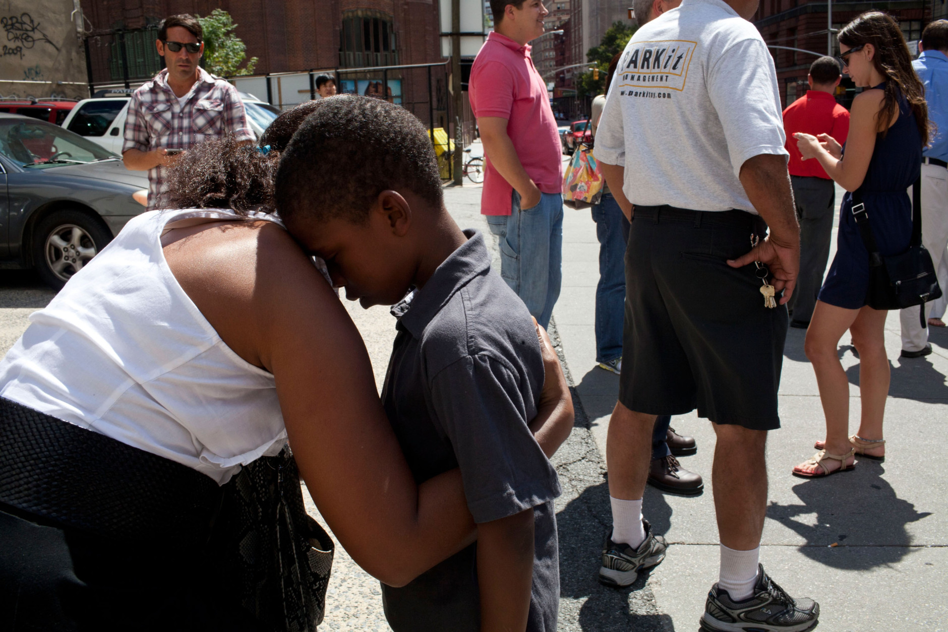 NEW YORK, NY - AUGUST 23:  Suzanne Beatty comforts her son Quentin Beatty, 7, on a street in TriBeCa after a 5.8  earthquake struck on August 23, 2011 in New York, United States. The epicenter of the 5.8  earthquake was located near Louisa in central Virginia. Two nuclear power plants at the North Anna Power Station in the same county were reportedly taken offline. (Photo by Andrew Burton/Getty Images)