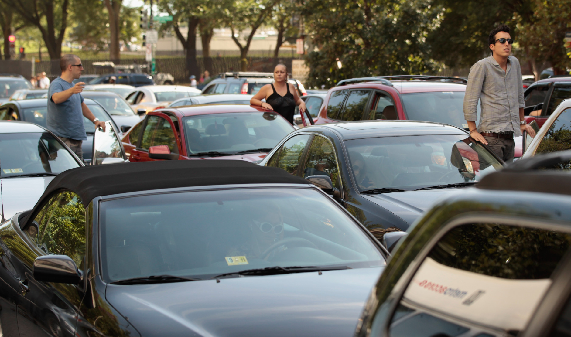 WASHINGTON, DC - AUGUST 23:  Drivers climb out of their cars to survey a traffic jam on 14th Street NW near the Ronald Reagan Building after a 5.8 magnitude earthquake rattled the East Coast August 23, 2011 in Washington, United States. The quake, centered near Miner, Virginia, rattled states from Maine to North Carolina but produced no serious injuries or damage.  (Photo by Chip Somodevilla/Getty Images)