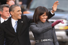 WASHINGTON, DC - JANUARY 21:  U.S. President Barack Obama and first lady Michelle Obama wave to supporters as they walk the inaugural parade route down Pennsylvania Avenue January 21, 2013 in Washington, DC. President Obama took the oath of office earlier in the day during a ceremony on the west front of the U.S. Capitol.  (Photo by Chip Somodevilla/Getty Images)