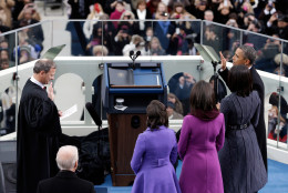WASHINGTON, DC - JANUARY 21:  U.S. President Barack Obama (R) is sworn in by Supreme Court Chief Justice John Roberts as First lady Michelle Obama and daughters, Sasha Obama and Malia Obama look on during the public ceremonial inauguration on the West Front of the U.S. Capitol January 21, 2013 in Washington, DC. Barack Obama was re-elected for a second term as President of the United States.   (Photo by Rob Carr/Getty Images)