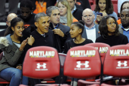 COLLEGE PARK, MD - NOVEMBER 17:  US President Barack Obama with his daughters Malia (L) and Sasha (R) and wife Michelle in their seats before a college basketball game between the Oregon State Beavers and the Maryland Terrapins on November 17, 2013 at the Comcast Center in College Park, Maryland.  (Photo by Mitchell Layton/Getty Images)