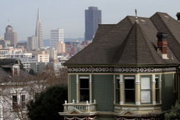 SAN FRANCISCO, CA - FEBRUARY 18:  A victorian home stands next to the San Francisco skyline on February 18, 2014 in San Francisco, California. According to a report by mortgage resource site HSH.com, an annual salary of $115,510 is needed to purchase a house in San Francisco where the median    home price is $682,410. The report included 25 of the nations largest metropolitan cities with Cleveland, Ohio being the cheapest with a needed salary of $19,435 to purchase a home.  (Photo by Justin Sullivan/Getty Images)