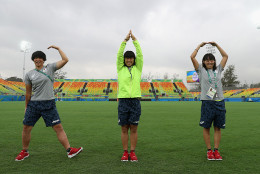 RIO DE JANEIRO, BRAZIL - AUGUST 03:  Mitsugi Kana (L), Taniguchi Noriko and Yokoo Chisato (R) of the Japan Women's rugby team spell out the word RIO as they visit the Deodora Olympic rugby stadium during the build up to the Rio Olympic Games on August 3, 2016 in Rio de Janeiro, Brazil.  (Photo by David Rogers/Getty Images)