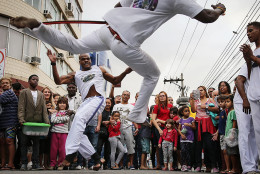 RIO DE JANEIRO, BRAZIL - AUGUST 03:  Brazilians perform capoeira, a Brazilian martial art mixing dance and music, ahead of the arrival of the Olympic torch relay in Rio's North Zone on August 3, 2016 in Rio de Janeiro, Brazil. The Rio 2016 Olympic Games commence on August 5.  (Photo by Mario Tama/Getty Images)