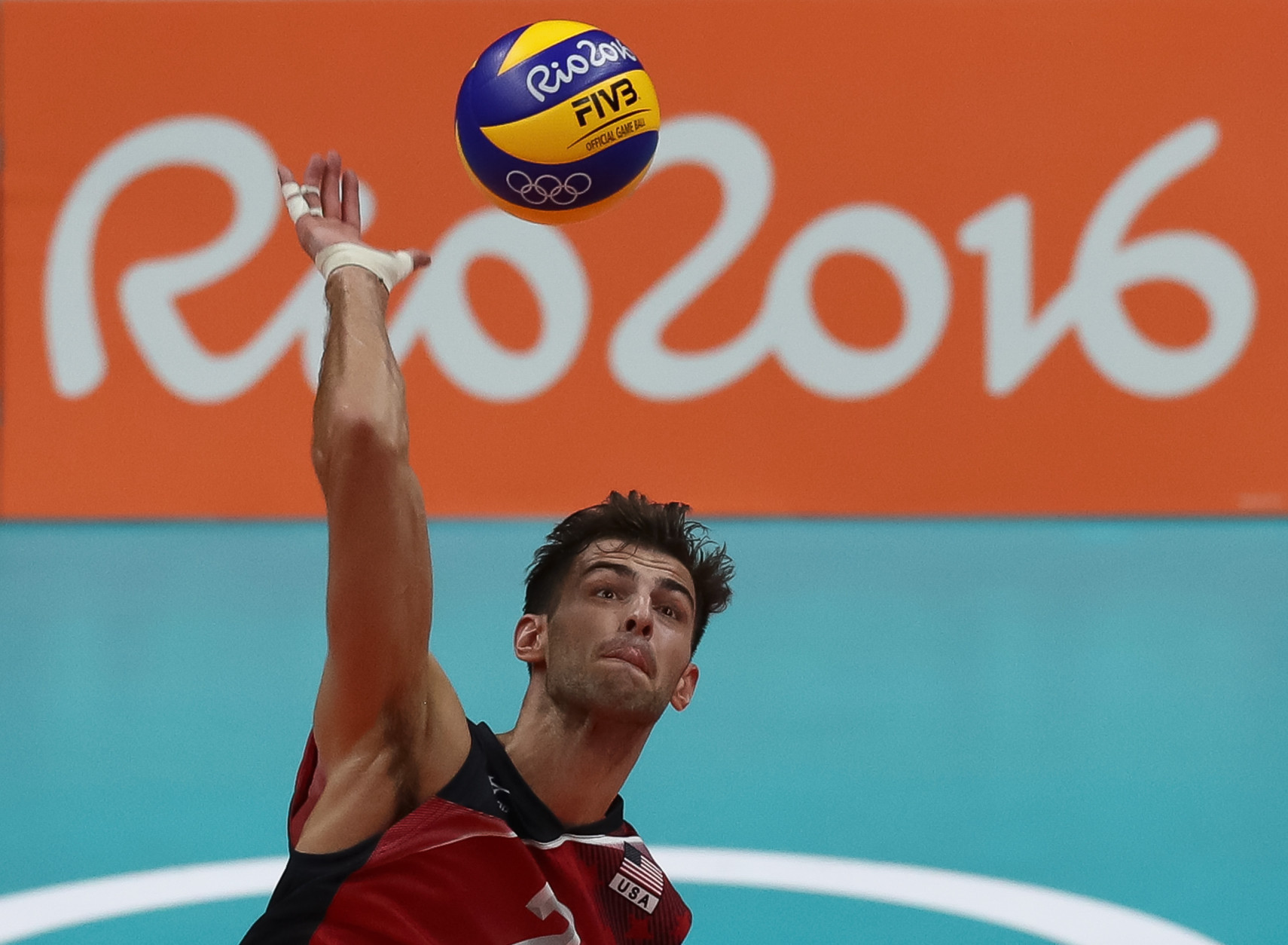 RIO DE JANEIRO, BRAZIL - AUGUST 09:  Aaron Russell of the United States spikes the ball during the men's qualifying volleyball match between the United States and Italy on Day 4 of the Rio 2016 Olympic Games at the Maracanazinho on August 9, 2016 in Rio de Janeiro, Brazil.  (Photo by Buda Mendes/Getty Images)