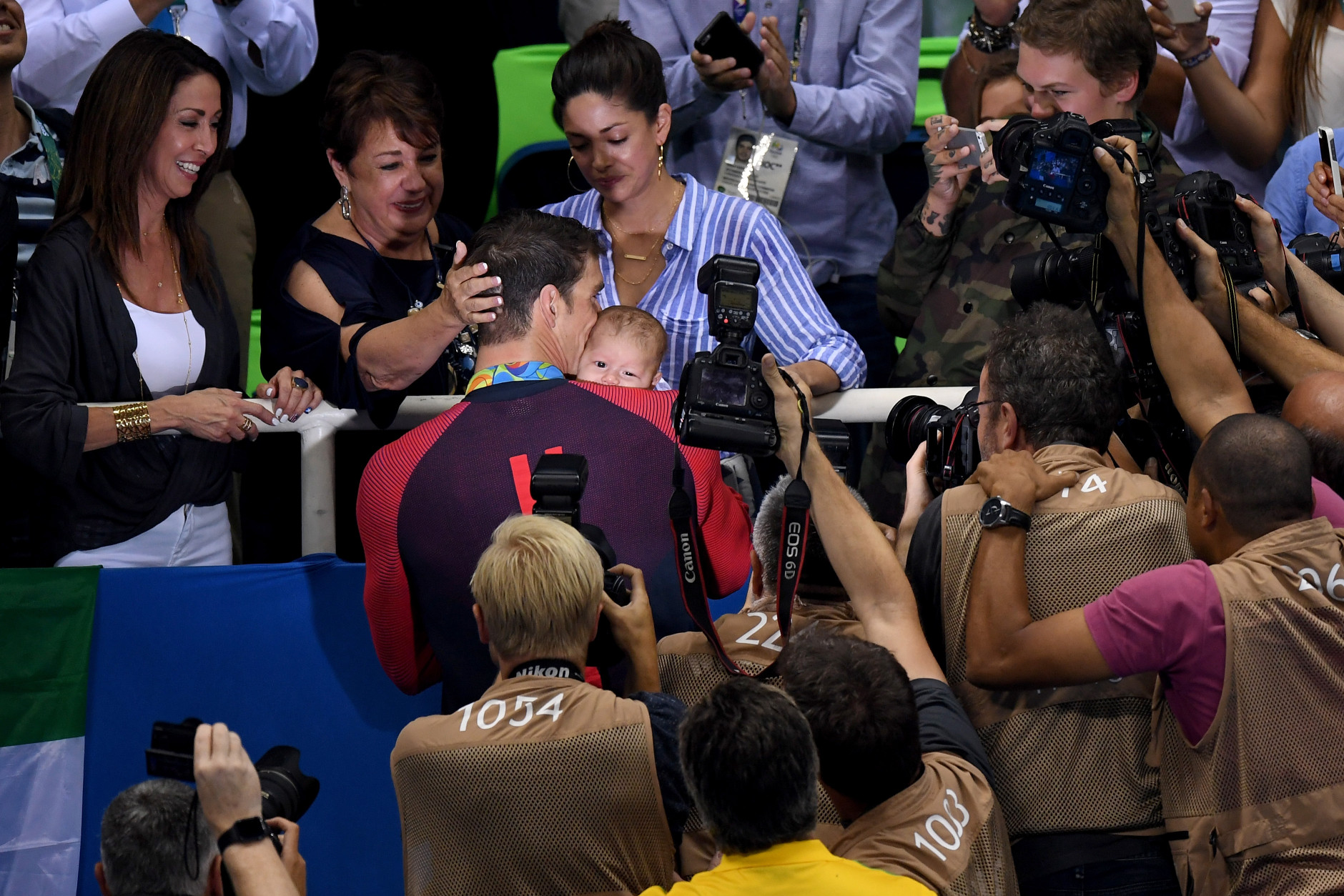 RIO DE JANEIRO, BRAZIL - AUGUST 09:  Gold medalist Michael Phelps of the United States celebrates with his mother Deborah Phelps, fiancee Nicole Johnson and son Boomer during the medal ceremony for the Men's 200m Butterfly Final on Day 4 of the Rio 2016 Olympic Games at the Olympic Aquatics Stadium on August 9, 2016 in Rio de Janeiro, Brazil.  (Photo by David Ramos/Getty Images)