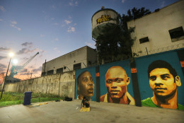 RIO DE JANEIRO, BRAZIL - AUGUST 17:  Artists put the finishing touches on a new mural of street art honoring the first Olympic refugee team during the Rio 2016 Olympic Games on August 17, 2016 in Rio de Janeiro, Brazil. The graffitti, created by the artists Rodrigo Sini and Cety Soledade, honors the stateless refugees, six men and four women, who hail from South Sudan, Syria, the Deomocratic Republic of Congo and Ethiopia.  (Photo by Mario Tama/Getty Images)