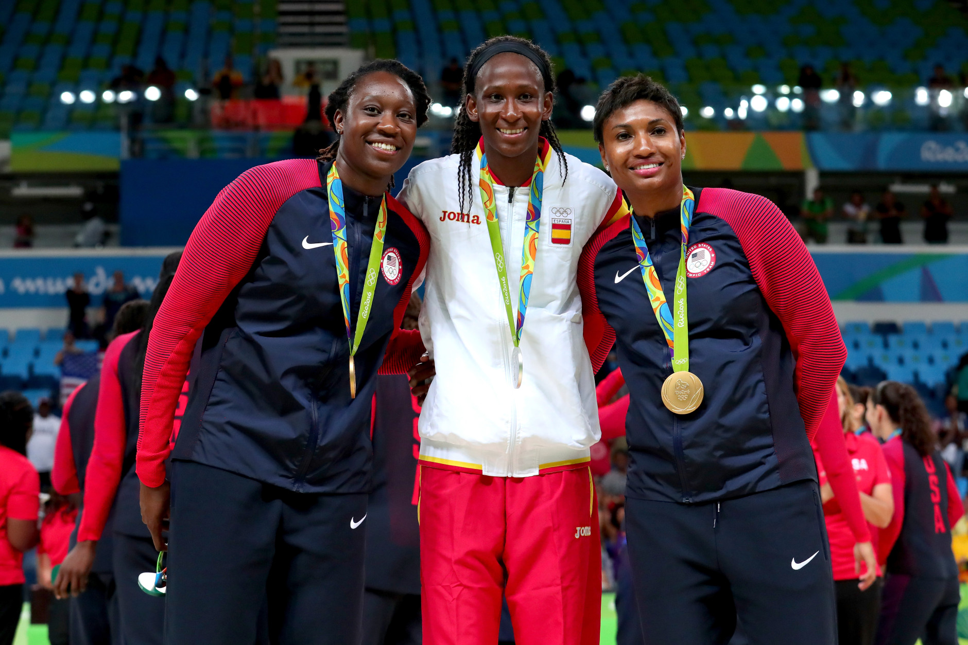 RIO DE JANEIRO, BRAZIL - AUGUST 20:  (L-R) Gold medalist Tina Charles #14 of United States, Silver medalist Astou Ndour Gueye #45 of Spain, and gold medalist Angel Mccoughtry #8 of United States celebrate after the Women's Basketball competition on Day 15 of the Rio 2016 Olympic Games at Carioca Arena 1 on August 20, 2016 in Rio de Janeiro, Brazil.  (Photo by Tom Pennington/Getty Images)