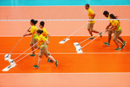 RIO DE JANEIRO, BRAZIL - AUGUST 21: Court officials clean the surface during the Men's Bronze Medal Match between United States and Russia on Day 16 of the Rio 2016 Olympic Games at Maracanazinho on August 21, 2016 in Rio de Janeiro, Brazil.  (Photo by Tom Pennington/Getty Images)