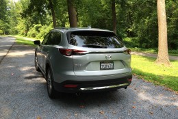 The rear of the Mazda CX-9 departs from the usual boring look with dual exhaust pipes and the different trim colors, and the bumper has some tasteful chrome accents. (WTOP/Mike Parris)