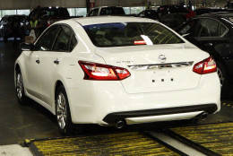 In this April 6, 2016, photograph, a newly-assembled Altima sedan rolls off the line and passes underneath a tally board at the Nissan Canton Vehicle Assembly Plant in Canton, Miss. Nissan product models assembled include the Altima, Armada, NV Cargo Van, NV Passenger Van, Murano, Titan King Cab and Crew Cab and the Frontier King Cab and Crew Cab. (AP Photo/Rogelio V. Solis)
