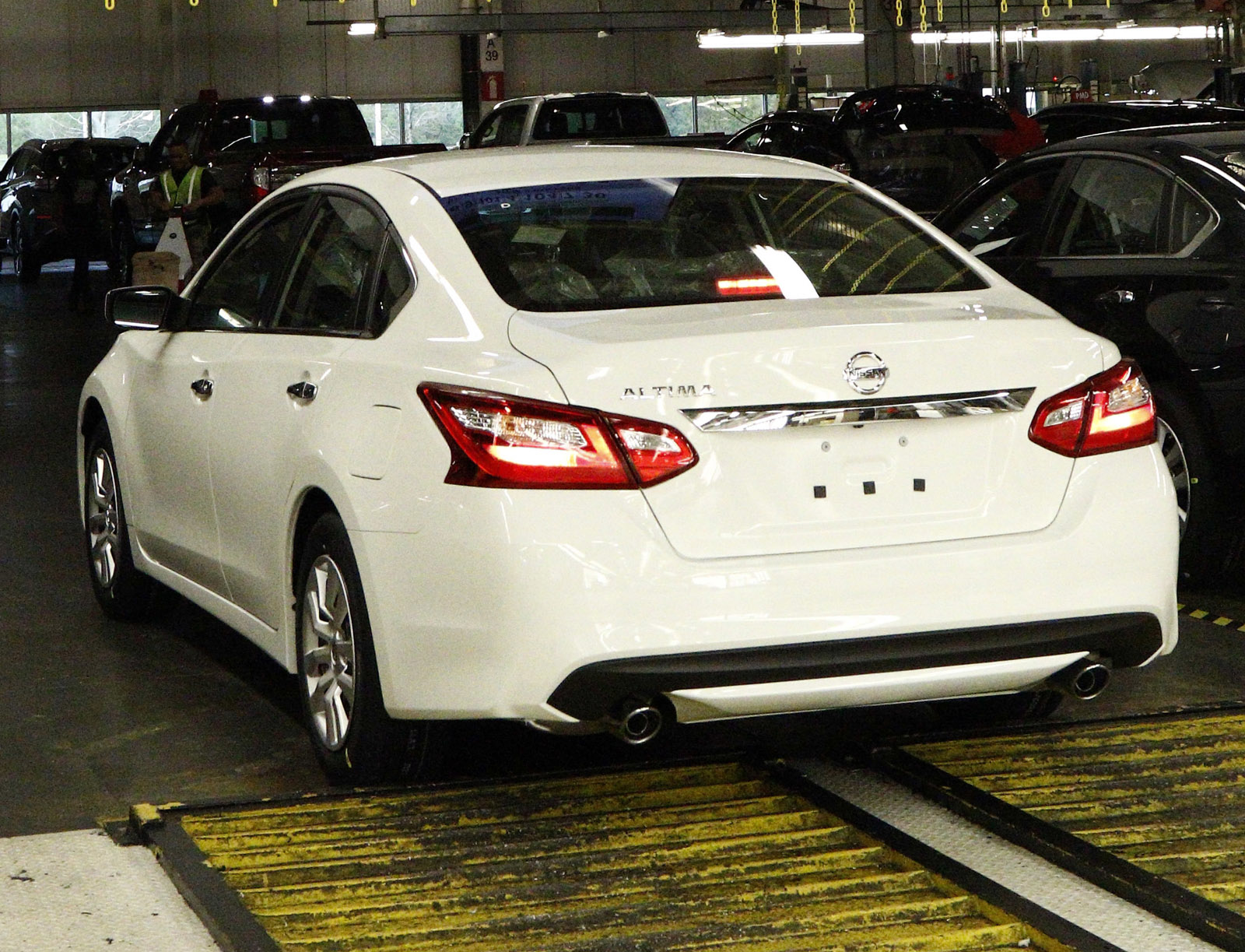 In this April 6, 2016, photograph, a newly-assembled Altima sedan rolls off the line and passes underneath a tally board at the Nissan Canton Vehicle Assembly Plant in Canton, Miss. Nissan product models assembled include the Altima, Armada, NV Cargo Van, NV Passenger Van, Murano, Titan King Cab and Crew Cab and the Frontier King Cab and Crew Cab. (AP Photo/Rogelio V. Solis)