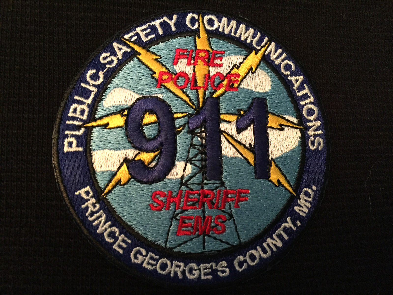 This WTOP file photo shows the logo on a Prince George's County 911 call-taker's uniform. (WTOP/Michelle Basch)