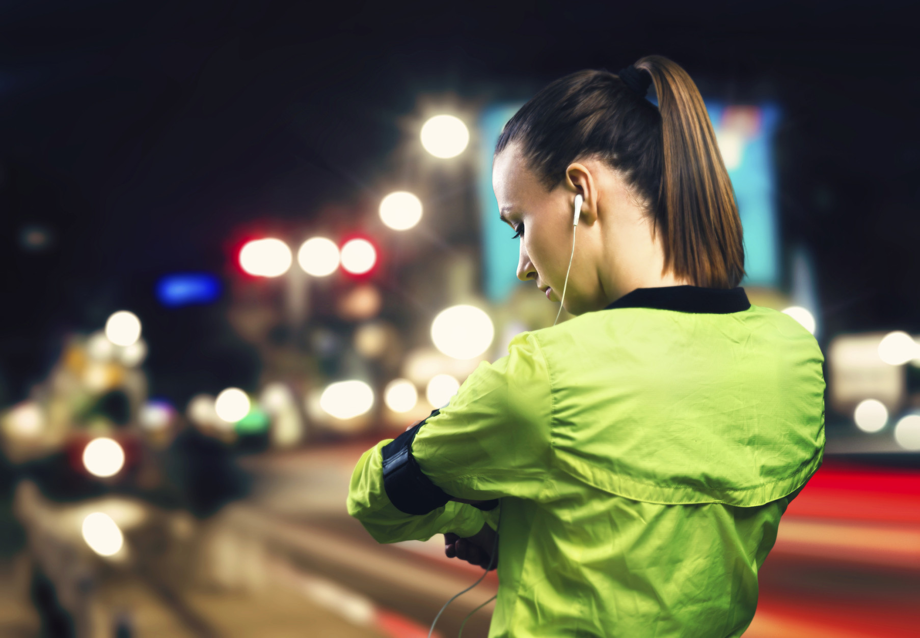Young woman jogging at night in the city