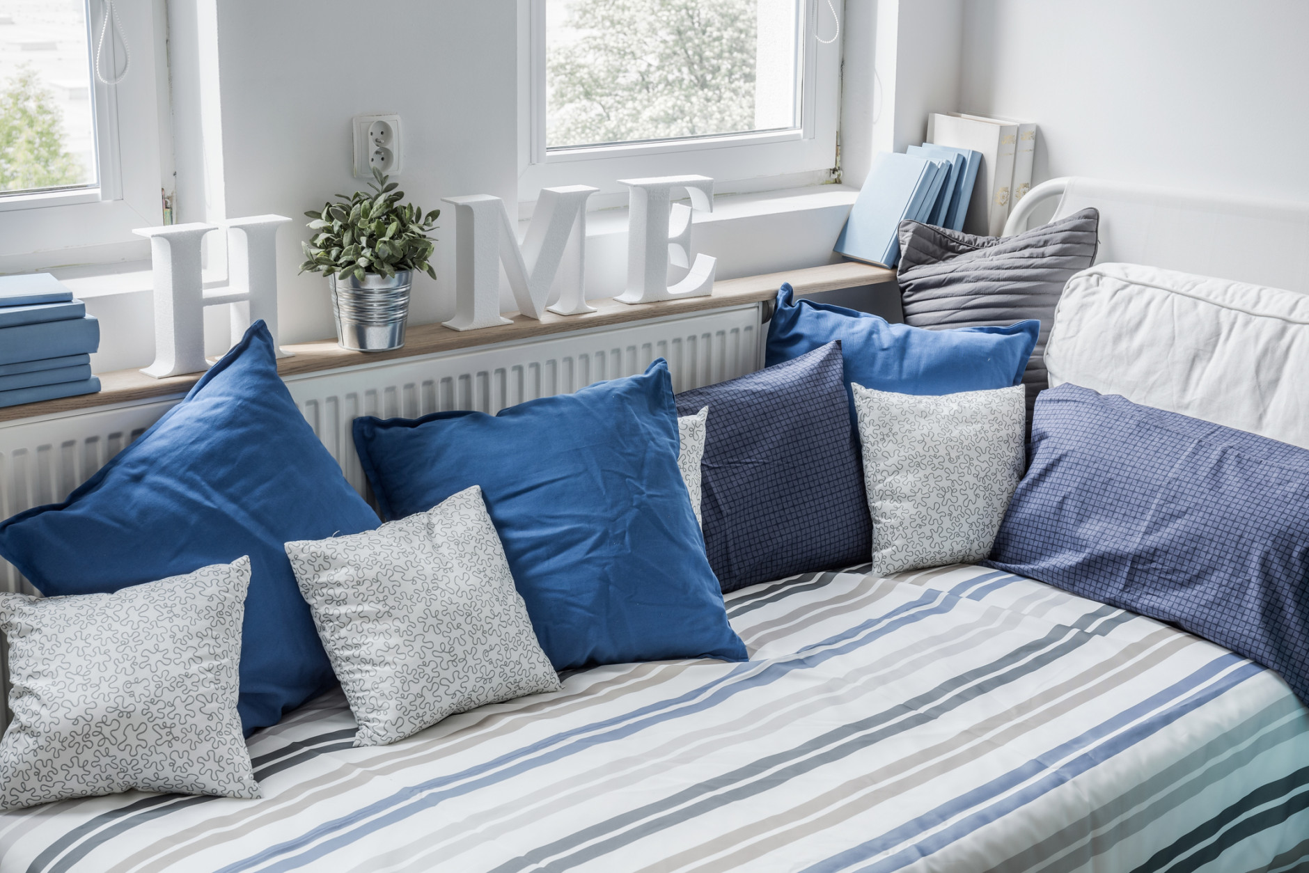 White and blue bedding set on the bed