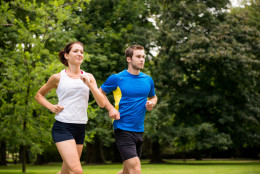 Fitness couple - young man and woman jogging outdoor in nature