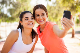 Beautiful girls taking a selfie with a smart phone before going for a run outdoors