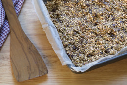 Quinoa baking bars in baking pan and spatula.