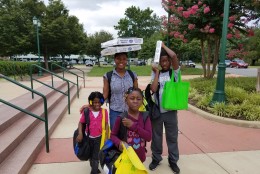 The Alot family loads up on supplies during the Prince George's County Back to School Fair. The first day of school is Aug. 23, 2016. (WTOP/Allison Keyes)