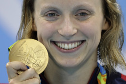 United States' Katie Ledecky shows off her gold medal in the women's 800-meter freestyle medals ceremony during the swimming competitions at the 2016 Summer Olympics, Friday, Aug. 12, 2016, in Rio de Janeiro, Brazil. (AP Photo/Michael Sohn)