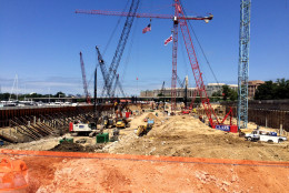 In this July 2015 WTOP file photo, construction work begins at The Wharf in Southwest D.C., a new development that will include office, retail and residential space. The Council of Governments reports that commercial real estate construction in the Washington region fell 31 percent in 2015 due largely to a slowdown in office construction. (WTOP File Photo/Ari Ashe)