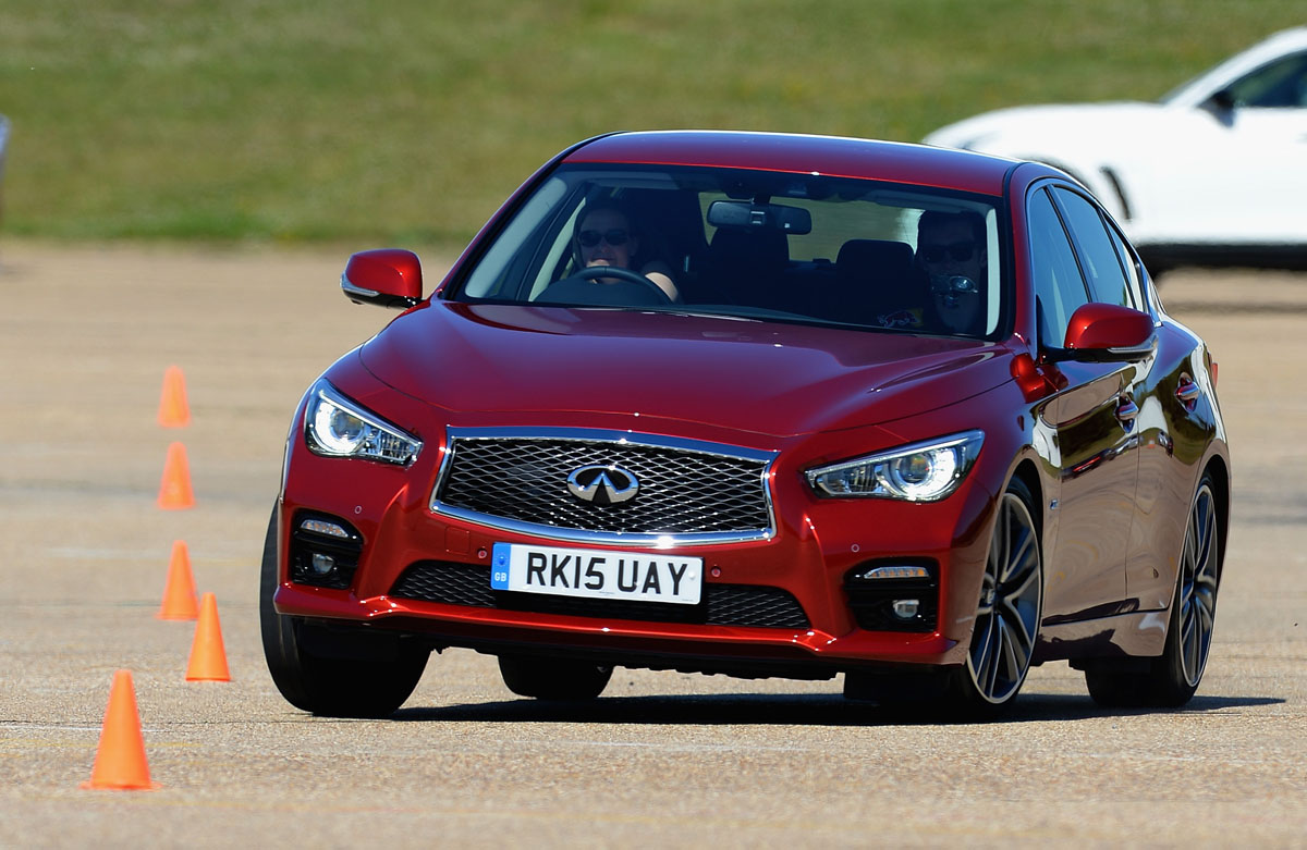 BEDFORD, ENGLAND - JUNE 30:  Guests drive an Infiniti Q50 through a slalom as they test the handling during the Infiniti Track Driving Experince at Millbrook Proving Ground on June 30, 2015 in Bedford, England.  (Photo by Christopher Lee/Getty Images for Infiniti Red Bull)