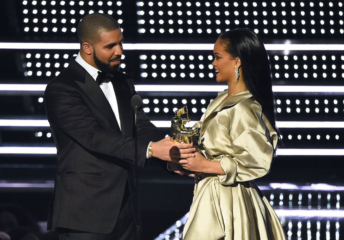 In this Aug. 28, 2016, file photo, Drake, left, presents the Michael Jackson Video Vanguard Award to Rihanna at the MTV Video Music Awards at Madison Square Garden in New York. Collectively, the pair accounted for nearly half of the top 10 most-streamed songs on music streaming site Spotify this summer.  (Photo by Charles Sykes/Invision/AP, File)