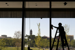 A worker cleans a window at the National Museum of African American History and Culture in Washington, Wednesday, Sept. 14, 2016, during a press preview. (AP Photo/Susan Walsh)