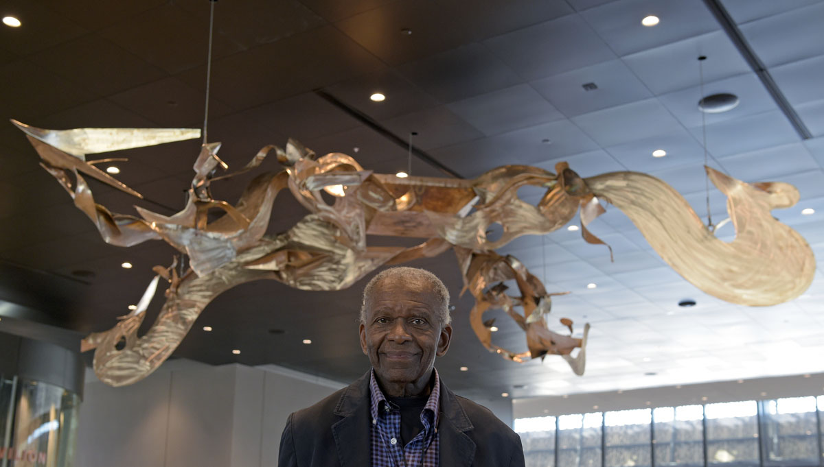 Richard Hunt, an African-American abstract sculptor and artist, stands with his sculpture on display at the National Museum of African American History and Culture in Washington, Wednesday, Sept. 14, 2016, during a press preview. (AP Photo/Susan Walsh)
