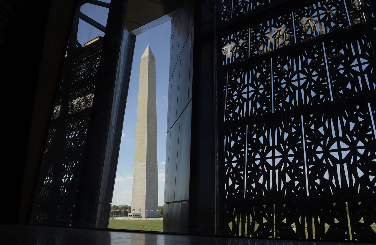 The Washington Monument is framed by a window at the National Museum of African American History and Culture in Washington, Wednesday, Sept. 14, 2016, during a press preview. (AP Photo/Susan Walsh)