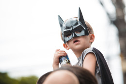 $. Batman characters. A child with batman costume has fun during the street carnival. (Mauricio Santana/Getty Images)