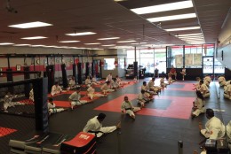 A class stretches on the mats at one of Enshin Karate's Northern Virginia locations. (Courtesy Nima Mazhari)
