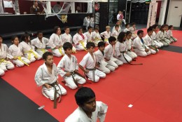 Students gather on the dojo mat at one of Enshin Karate's Northern Virginia locations. (Courtesy Nima Mazhari)