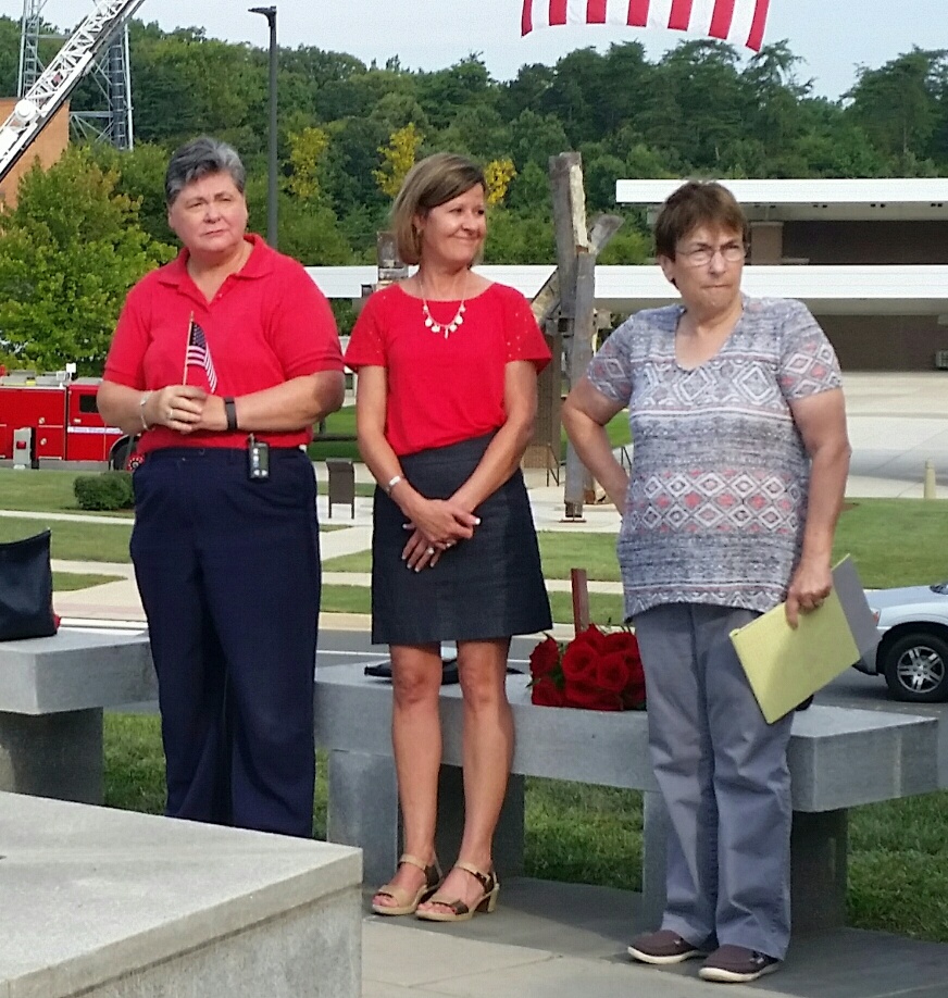 Laurie Laychak, middle, attends the 9/11 Memorial in Prince William County on Friday. (WTOP/Kathy Stewart) 