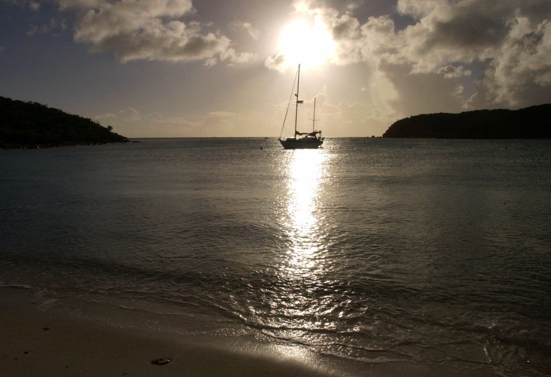A lone sailboat rests in the waters of Saltpond Bay at St. John, U.S. Virgin Islands, Dec. 17, 2000. With a large portion of land and water protected within the boundaries of a national park, St. John remains perhaps the most pristine of the Virgin Islands. (AP Photo/ Tomas van Houtryve)