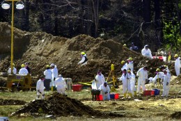 FBI investigators continue their excavation at the Shanksville, Pa., crash site of United Flight 93 on Sunday, Sept. 16, 2001. (AP Photo/Gene J. Puskar)