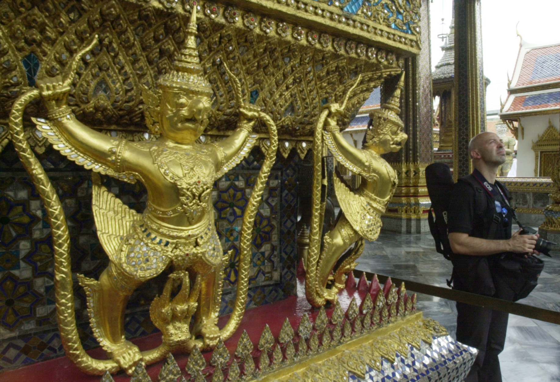 Marco Solas of Brisbane, Australia, tours Thailand's Grand Palace Wednesday, Aug. 4, 2004, in Bangkok.  Thai officials note that tourism is on the increase by more than 20 per cent over this time last year.  Tourism is one of top revenue producers for the Southeast Asia nation.  (AP Photo/Sakchai Lalit)