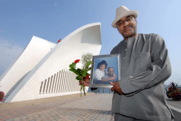 Joseph Jones, whose wife Felicia Dunn-Jones died of lung disease five months after inhaling toxic dust in the 9/11 terrorist attacks, poses with their portrait at the 9/11 Memorial on Staten Island, New York on Thursday, Sept. 6, 2007. Her name has been added to the list of victims of the Sept. 11, 2001 attacks on the World Trade Center. (AP Photo/Henny Ray Abrams)