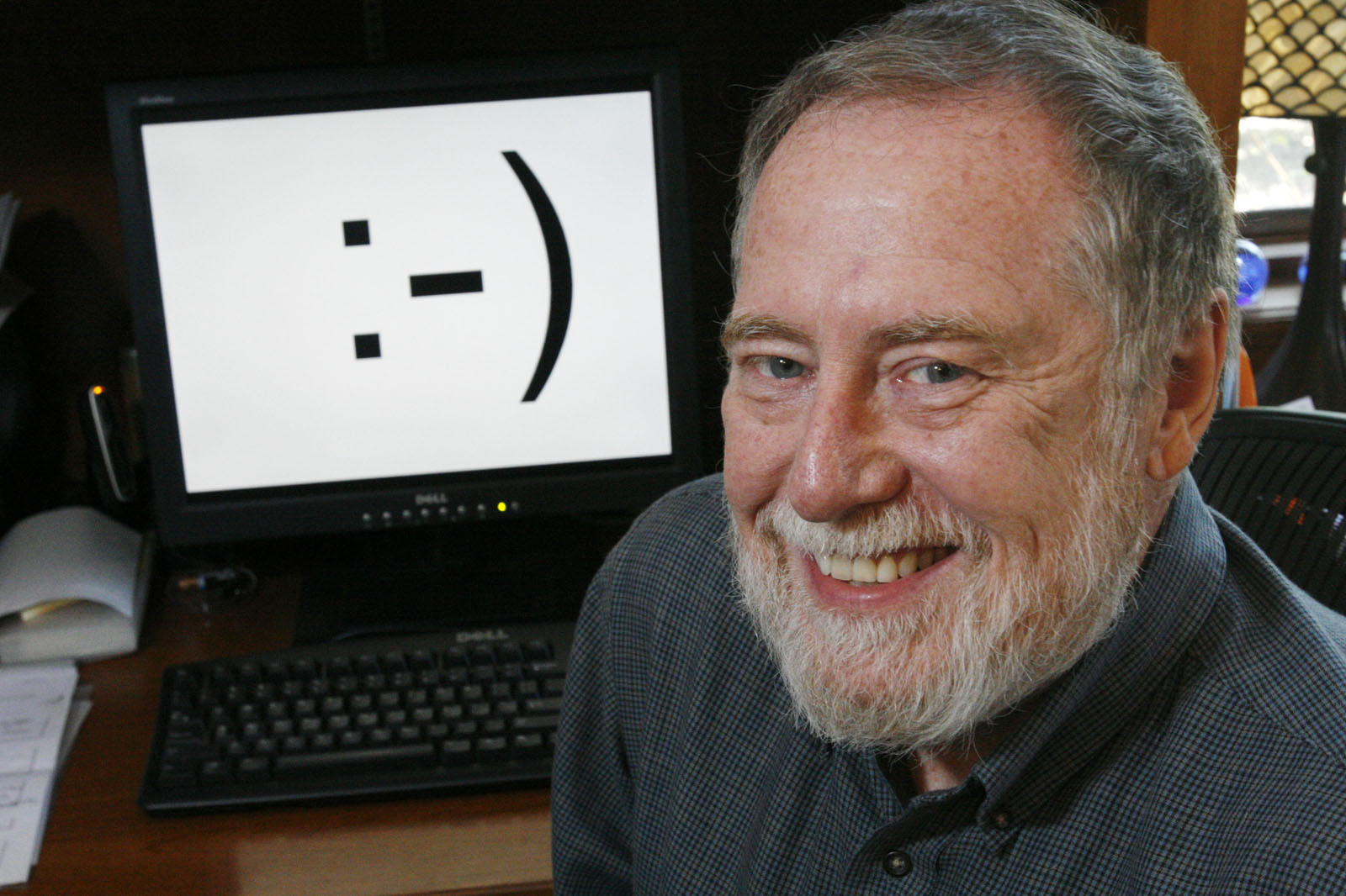 Carnegie Mellon professor Scott E. Fahlman is shown in his home office on Monday, Sept. 17, 2007, in Pittsburgh. Twenty-five years ago, three keystrokes _ a colon followed by a hyphen and a parenthesis _ were first used as a horizontal "smiley face" in a computer message by Fahlman, the university said.  Fahlman posted the emoticon in a message to an online electronic bulletin board at 11:44 a.m. on Sept. 19, 1982. (AP Photo/Gene J. Puskar)