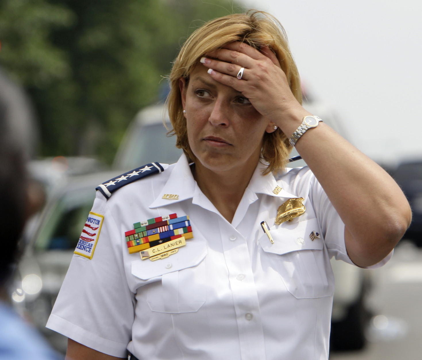 D.C. Police Chief Cathy Lanier wipes her forehead after talking with the media near the U.S. Holocaust Museum after a shooting at the museum in Washington, Wednesday, June 10, 2009.(AP Photo/Alex Brandon)