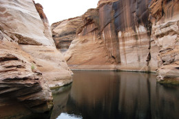 This Nov. 28, 2009 photo shows vermillion rock faces reflecting in the still waters of Lake Powell during a winter dawn boat tour in Northern Arizona. Lake Powell, boat party central in summer, is all yours in winter.   (AP Photo/Giovanna Dell'Orto)  NO SALES