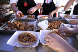 In this May 7, 2011 photo, workers make oyster and shrimp po-boy sandwiches in the Vucinovich's Restaurant food booth at the New Orleans Jazz and Heritage Festival in New Orleans. Food is a popular draw at the annual festival, and vendors must try out to have the chance to sell their products. (AP Photo/Patrick Semansky)