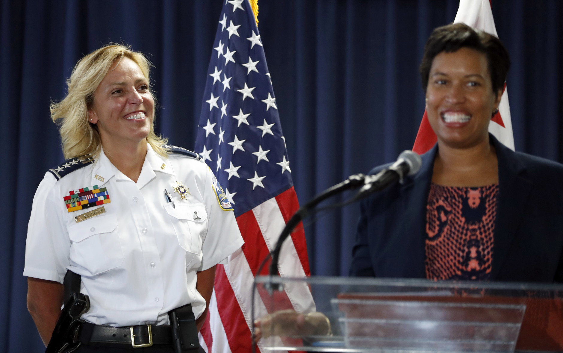 Washington police chief Cathy Lanier smiles at left as Washington Mayor Muriel Bowser speaks during a news conference, Tuesday, Aug. 16, 2016, in Washington. Lanier is stepping down to become head of security for the National Football League. (AP Photo/Alex Brandon)