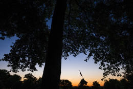 Sunrise silhouettes the U.S. Marine Corps Memorial in Arlington, Va. on a cloudless summer morning in the Nation's Capital area Tuesday, Aug. 23, 2016. (AP Photo/J. David Ake)