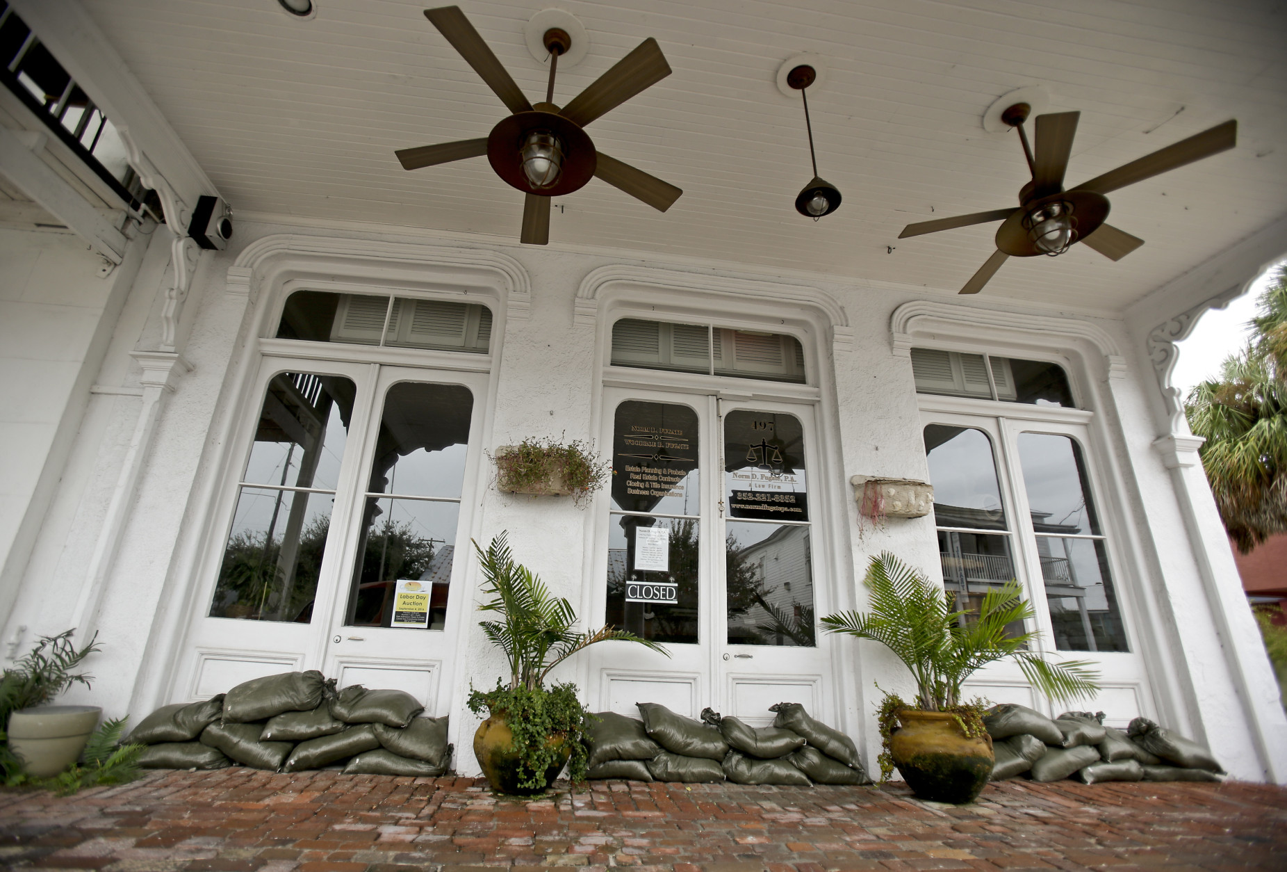 Sandbags line the doors of a business in Cedar Key, Fla. in preparation of Tropical Storm Hermine, Wednesday, Aug. 31, 2016. Forecasters say Hermine could be near hurricane strength by Thursday night as it approaches the Gulf Coast. (AP Photo/John Raoux)