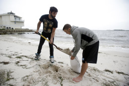 Daniel Fink, left, and Pete Stefani fill sandbags at the Cedar Cove Hotel as they prepare for Tropical Storm Hermine Thursday, Sept. 1, 2016, in Cedar Key, Fla. (AP Photo/John Raoux)
