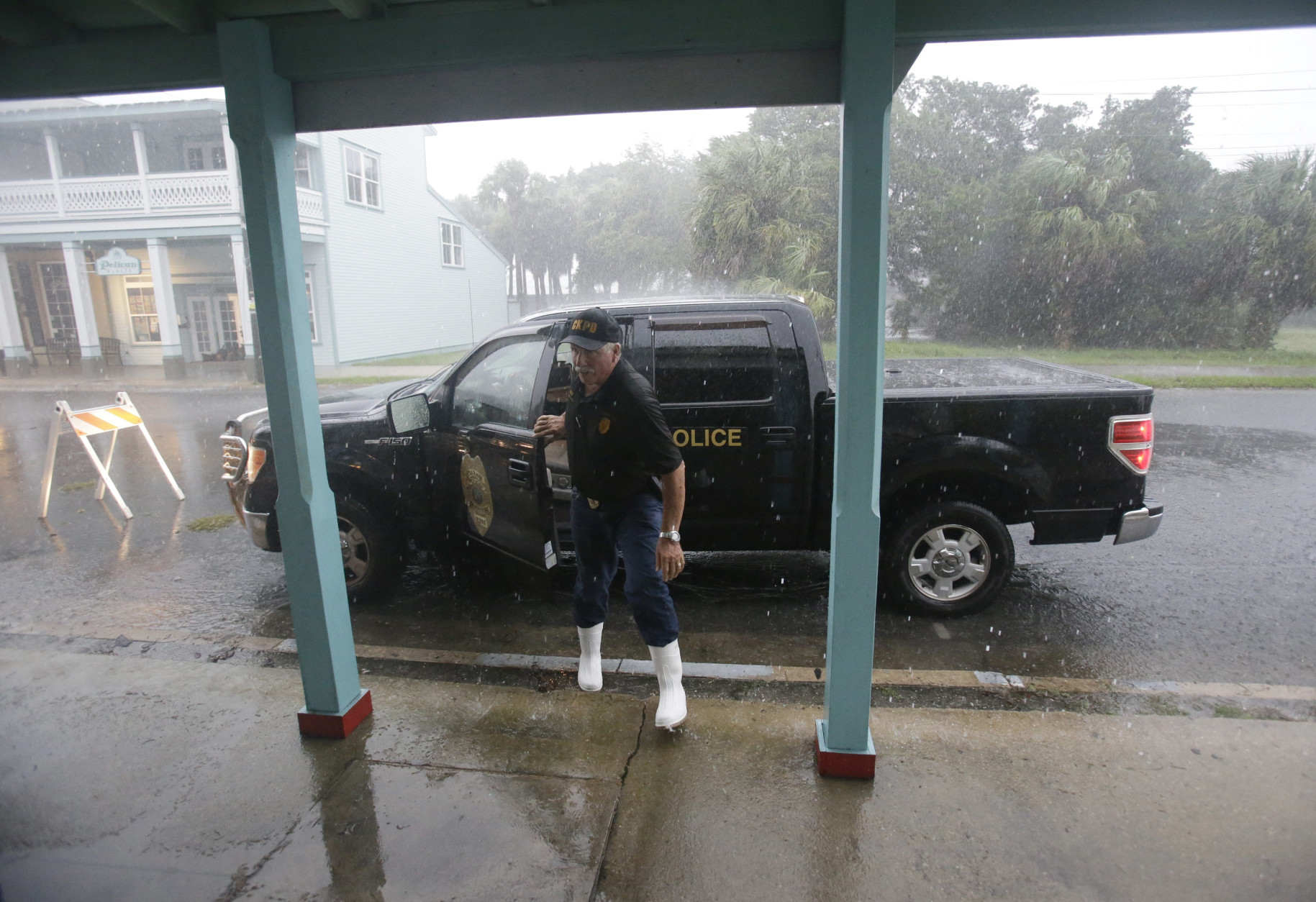 Cedar Key police chief Virgil Sandlin checks on the downtown area as Hurricane Hermine nears the Florida coast, Thursday, Sept. 1, 2016, in Cedar Key, Fla. Tropical Storm Hermine strengthened into a hurricane Thursday and steamed toward Florida's Gulf Coast, where people put up shutters, nailed plywood across store windows and braced for the first direct hit on the state from a hurricane in over a decade. (AP Photo/John Raoux)