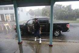 Cedar Key police chief Virgil Sandlin checks on the downtown area as Hurricane Hermine nears the Florida coast, Thursday, Sept. 1, 2016, in Cedar Key, Fla. Tropical Storm Hermine strengthened into a hurricane Thursday and steamed toward Florida's Gulf Coast, where people put up shutters, nailed plywood across store windows and braced for the first direct hit on the state from a hurricane in over a decade. (AP Photo/John Raoux)